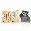 Personalized cream-colored stacked Namelet desk sign featuring the Bin Bandit Raccoon SideKick, a cute raccoon peeking from a trash can. Custom 3D printed desk decor by Embellish Queen.
