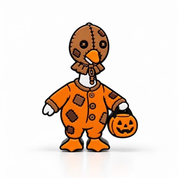 Goosebumps SideKick featuring a spooky-cute Halloween goose dressed in an orange patchwork costume with a stitched burlap mask, carrying a jack-o'-lantern candy bucket for festive Halloween desk decor.