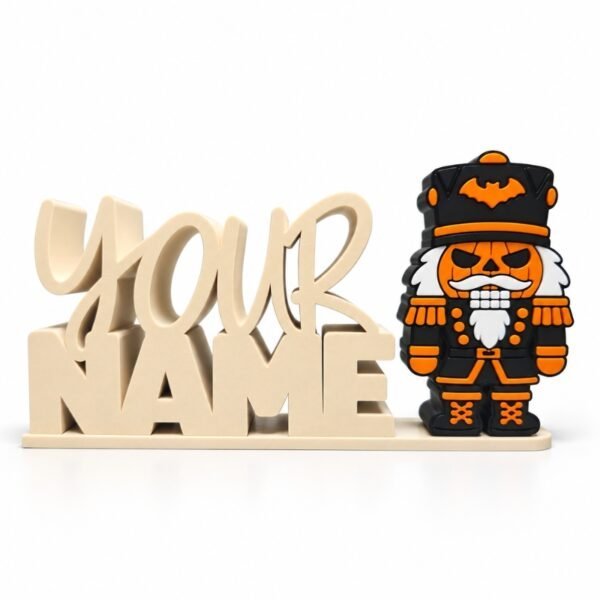 Jack-o-cracker Sidekick Jack-o-cracker Halloween SideKick featuring an orange jack-o'-lantern face, black nutcracker uniform, orange bat hat, and white beard, displayed beside a cream personalized Namelet on a white background.