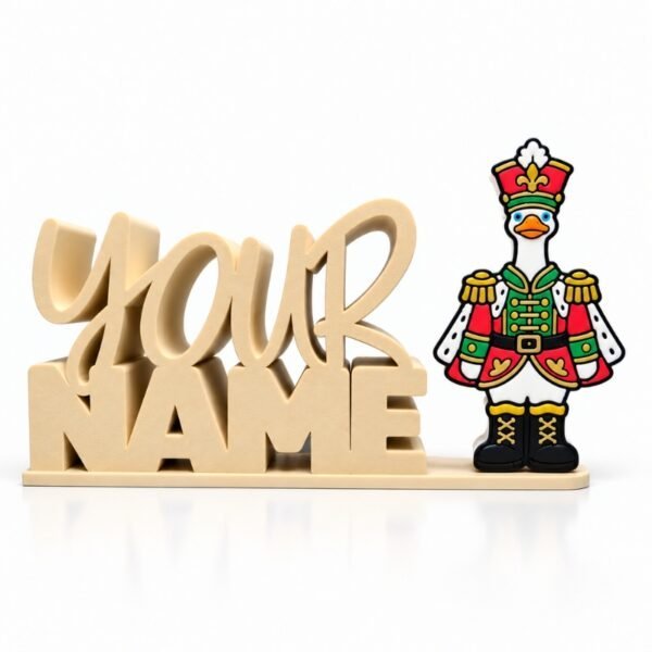 Nutcracker Goose SideKick Personalized 3D printed Namelet desk sign featuring the Nutcracker Goose SideKick in a festive red, green, and gold uniform. Custom interchangeable Christmas SideKick desk decor by Embellish Queen.